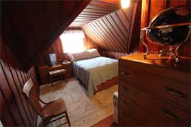The Captain's House - Wood paneled bedroom